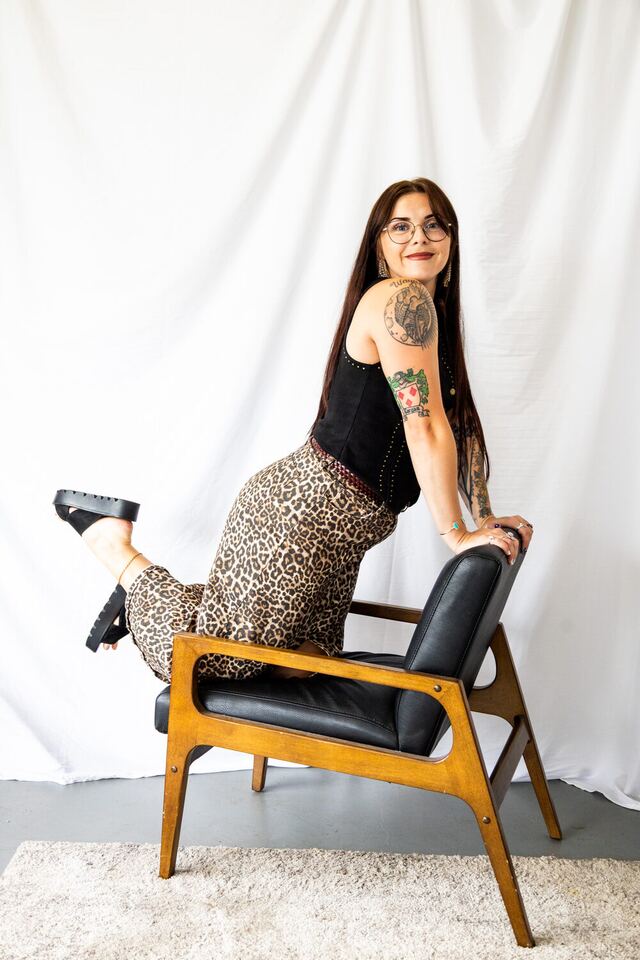 Alyssa leaning on the studio chair at Plush Beauty Bar